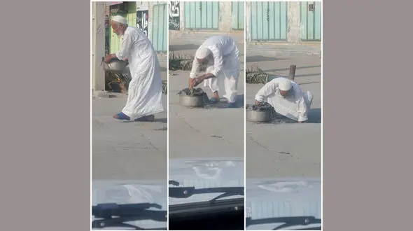 امام جمعه موقت گناوه در حال تمیز کردن ورودی فاضلاب + عکس