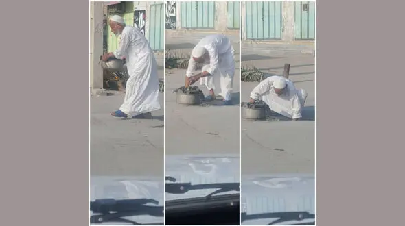 امام جمعه موقت گناوه در حال تمیز کردن ورودی فاضلاب + عکس