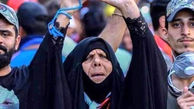 زن عراقی که به خاطر برد عراق مقابل ایران  جهانی شد! + عکس