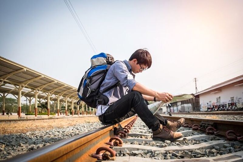 Traveler-Wearing-Backpack-Holding-Map-Railway-Train-Station-