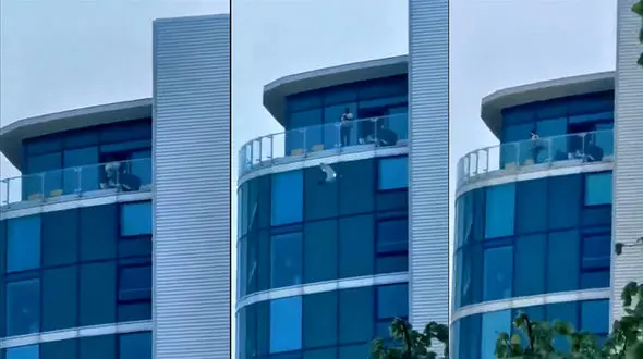 فیلم تیراندازی یک مرد از بالکن خانه اش+ فیلم / بریتانیا