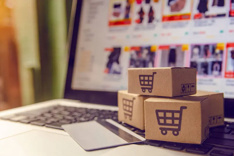 Several-Shoping-Boxes-And-A-Bank-Card-On-A-Laptop-showing-Online-Buying-