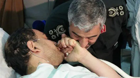 عکس / بوسه فرمانده سپاه بر دست یک بسیجی جانباز آشوب پاسداران