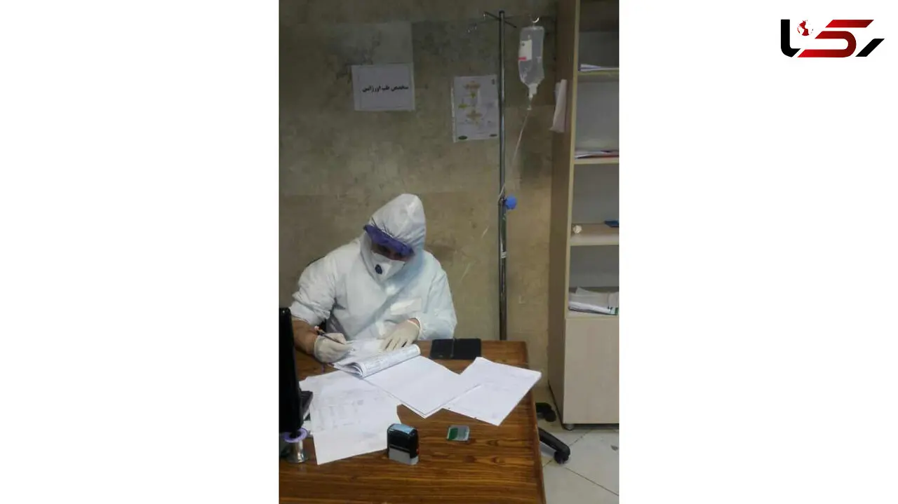 پزشکی که سرم به دست در حال کمک به مبتلایان به کرونا است  +عکس 