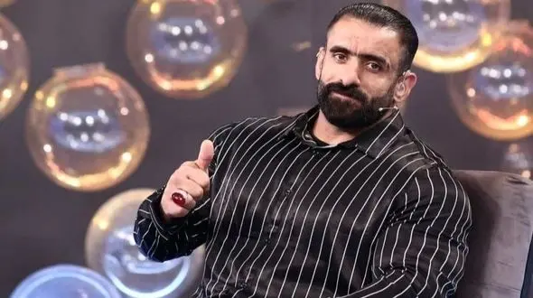 نگاهی به پذیرایی خانه ساده هادی چوپان با فرش ماشینی و پرده های معمولی و گُل گیاه /اصالت در اوج ثروت و محبوبیت