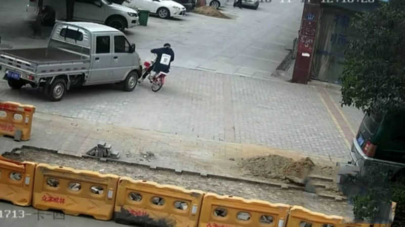 Rescuers-save-girl-knocked-over-and-trapped-by-pick-up-truck-in-China