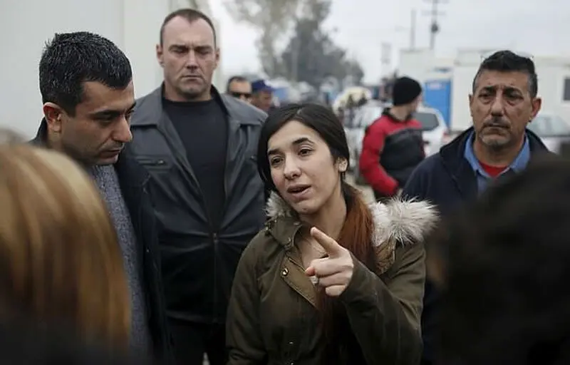 4786106-6243341-Nadia_Murad_walks_through_a_makeshift_camp_for_migrants_and_refu-a-40_1538744556572-w700