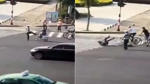 درگیری به خاطر لگد افسر پلیس به یک دوچرخه سوار در خیابان شلوغ +فیلم