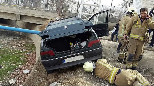تلاش آتش نشانان از  سقوط خودرو به رودخانه جلوگیری کرد + عکس